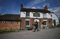 English pubs set for comeback, India battles record virus surge.jpg
