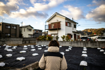 The 37-year-old son of death-row inmate Masumi Hayashi, who goes by the pseudonym of Koji Hayashi standing in front of the land of the family's previous house
