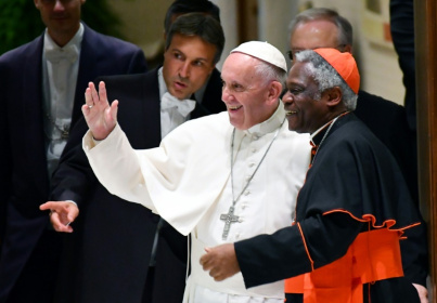 Pope Francis is flanked by Ghana's Cardinal Peter Turkson at the Vatican in 2016