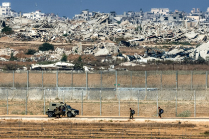 Israeli army soldiers walk towards an armoured vehicle at a position along the border fence with the Gaza Strip in southern Israel - Jack GUEZ (AFP)