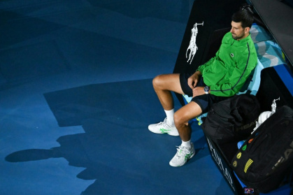 Serbia's Novak Djokovic waits for the presentation ceremony at the Australian Open - Paul Crock (AFP)