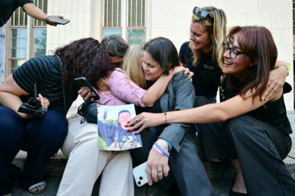 Plaintiffs' attorney Laura Marquez-Garrett, center, and family members celebrating the court win against Meta and YouTube - Frederic J. Brown (AFP)