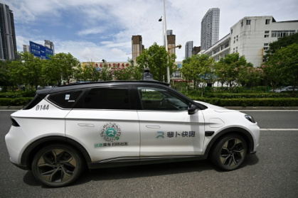 Baidu's driverless taxi service began charging for rides in Beijing in 2021 and operates in designated areas across several cities - Pedro PARDO (AFP)