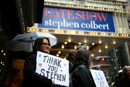 Outside the theater, supporters gathered holding signs reading 'thank you Stephen' - CHARLY TRIBALLEAU (AFP)