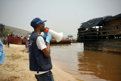 Yves Matwa, an Ebola outbreak response worker, tells passengers on Congo river ferries to brace for checks before they can enter the DR Congo capital Kinshasa - Sophie Douce (AFP)